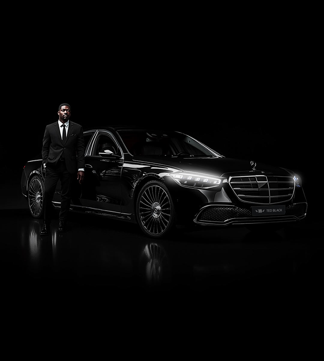 Chauffeur standing next to a luxury car.
